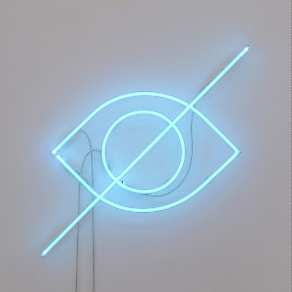 A neon sign of an eye with a line through the centre.