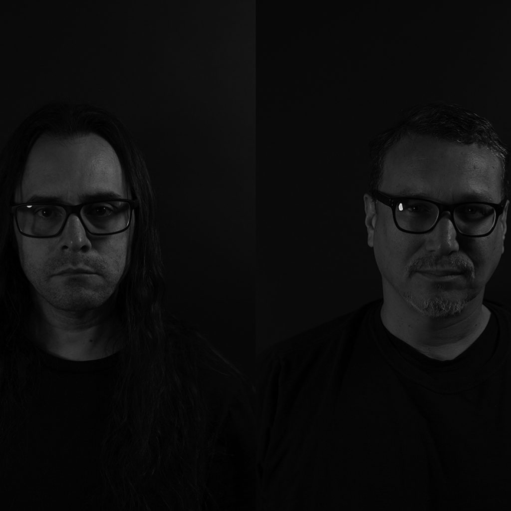 Headshots of Postcommodity standing in a dark room.