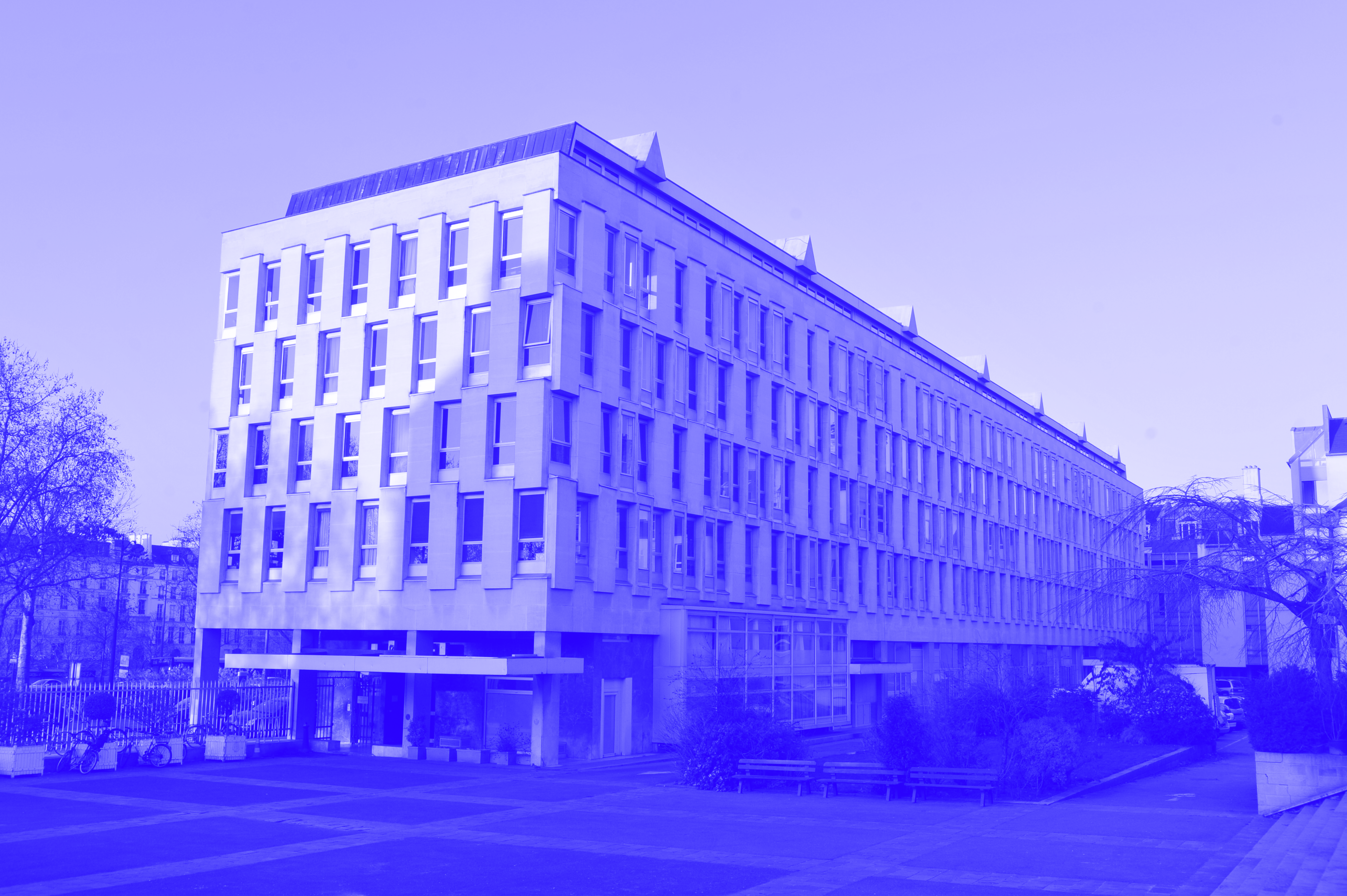 A blue and white photograph of the Cité des Arts Internationales in Paris