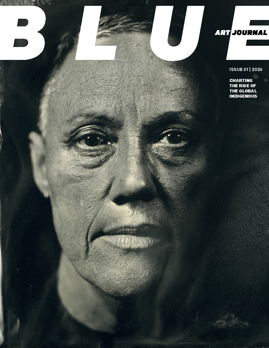 A mock-up of the front cover of the first issue of Blue Art Journal, showing a black and white photograph of a woman's face.