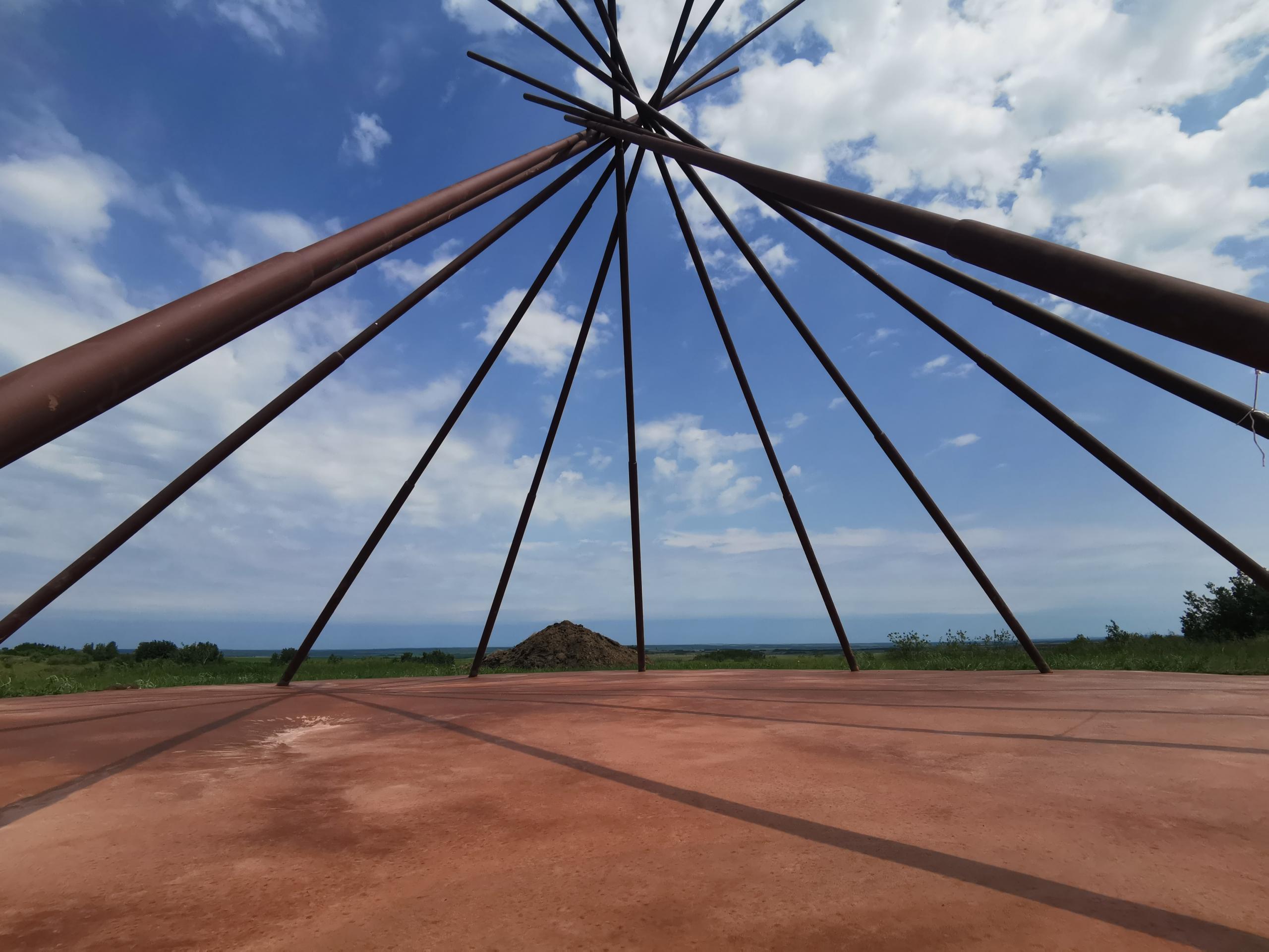 An image of a large wooden structure with a dirt floor